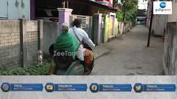தாயுடன் இருச்சக்கர வாகனத்தில் சுற்றுலா செல்லும் நபர்