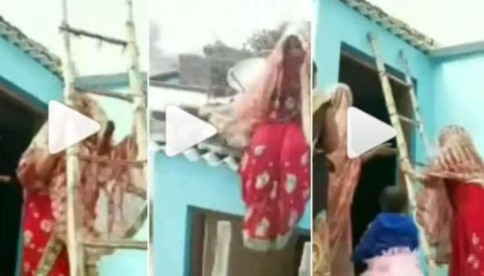 Viral Video: கூரை மீது ஏறி அமர்ந்து கீழே வர மறுத்த மணப்பெண், காரணம் என்ன?  title=