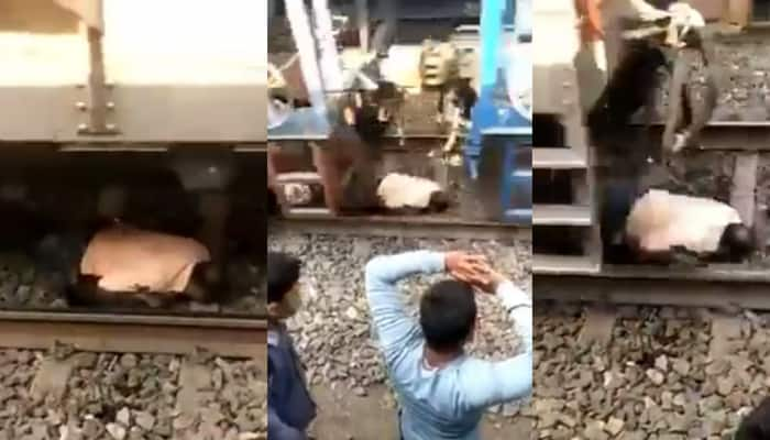 Video: குறுக்குவழியில் சென்று ரயிலுக்கு அடியில் மாட்டிய நபர்; கடைசி நொடிவரை திக்... திக்...திக் title=